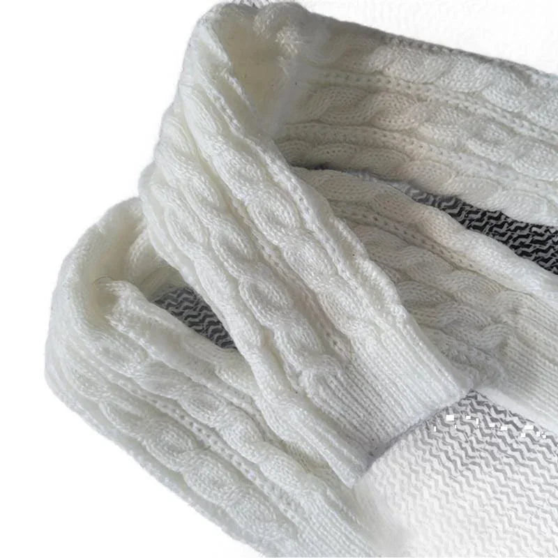 Close-up of white cable knit woolen sweater with textured pattern