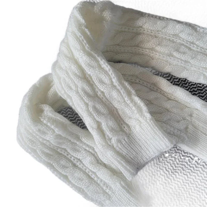 Close-up of white cable knit woolen sweater with textured pattern