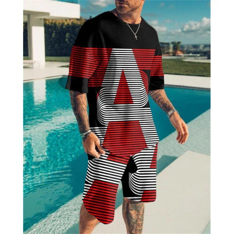 Man wearing red, black, and white graphic print T-shirt and shorts by a modern pool
