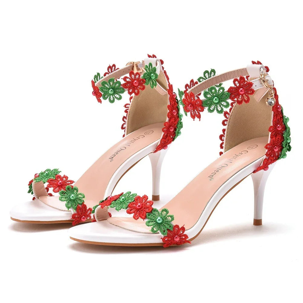 White high heel sandals with red and green floral lace and pearl embellishments