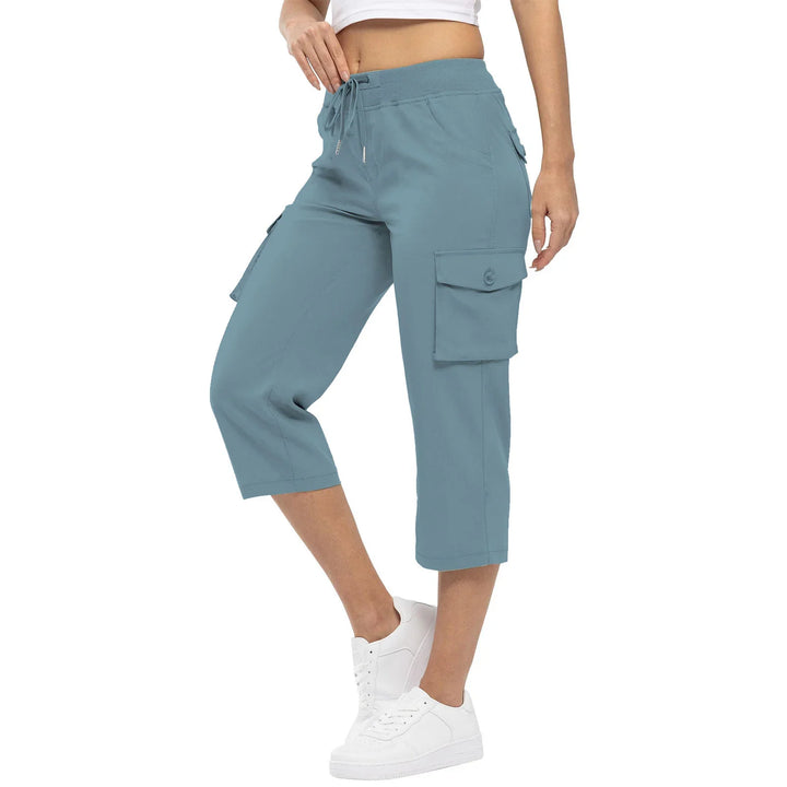 Woman wearing blue cropped cargo pants with drawstring waist and white sneakers