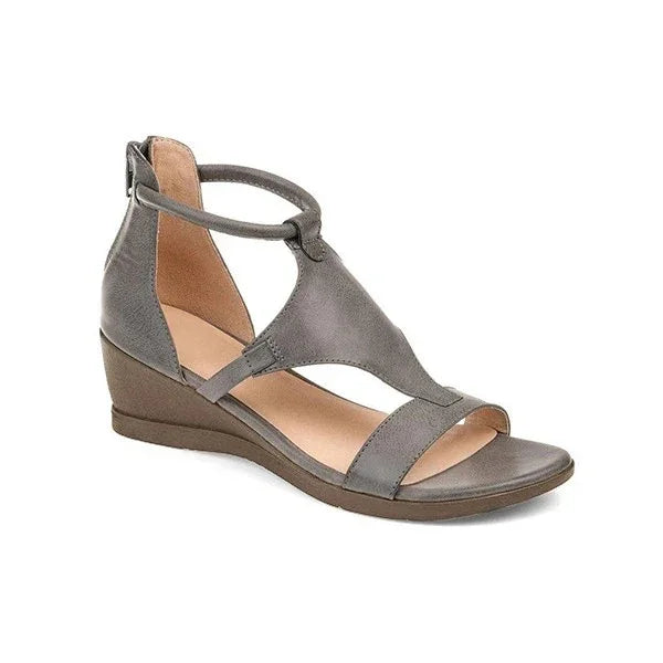 gray leather wedge sandal with ankle strap and open toe on white background