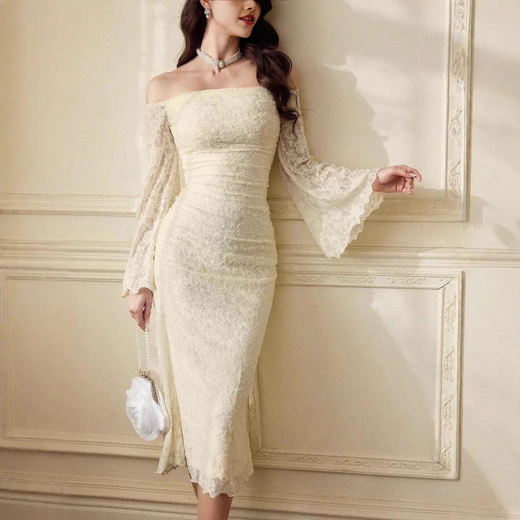 Woman in elegant off-shoulder lace cream midi dress with flared sleeves holding white purse