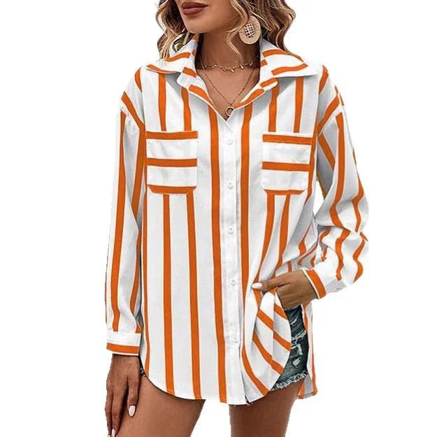 Woman wearing white button-up shirt with vertical orange stripes and front pockets, paired with denim shorts