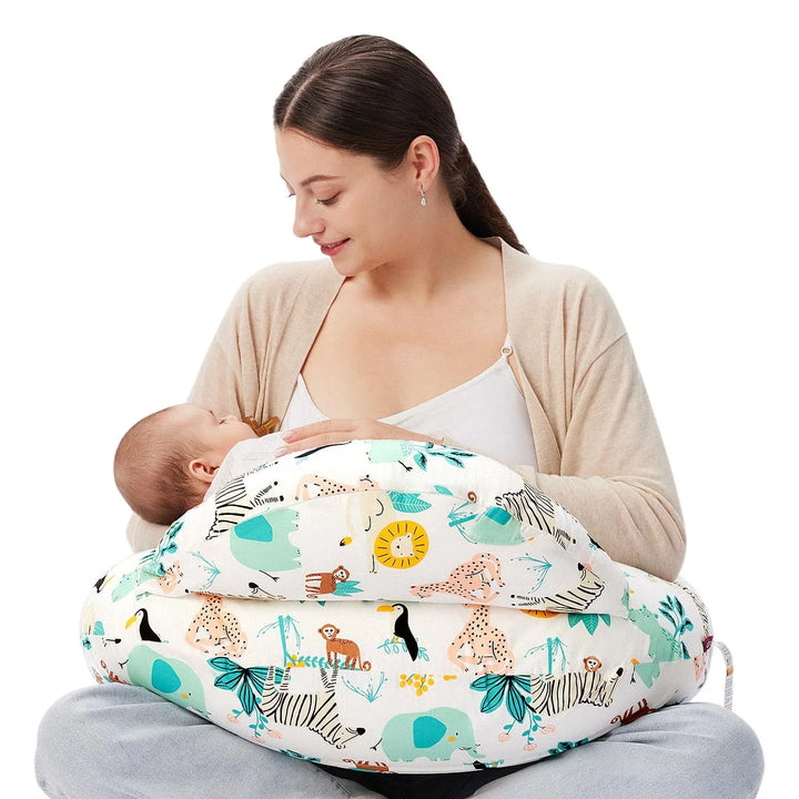 Mother breastfeeding baby using animal print nursing pillow with zebra, elephant, and lion designs