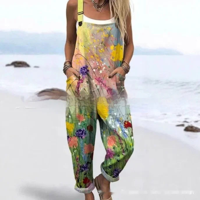 Woman wearing colorful floral print overalls with pockets on a beach background
