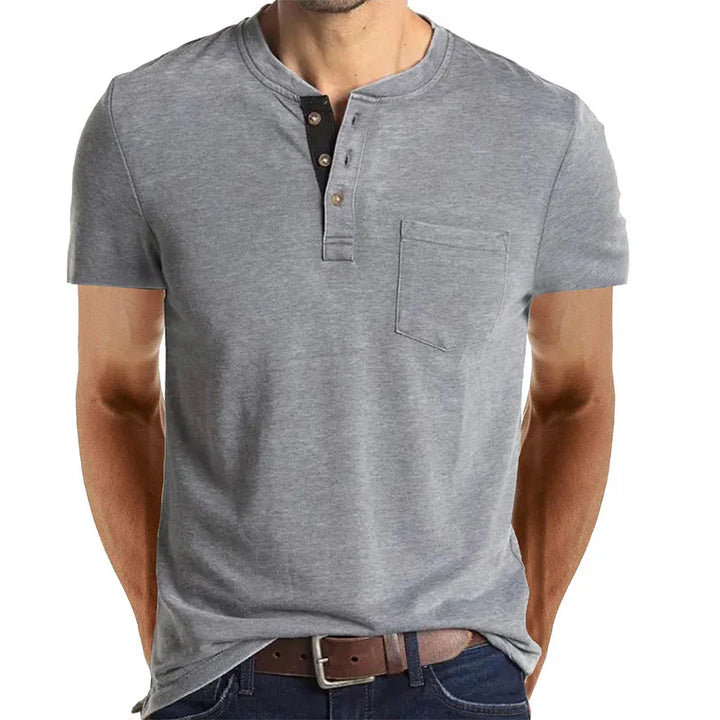 Man wearing a casual grey short-sleeve henley shirt with a chest pocket and brown belt