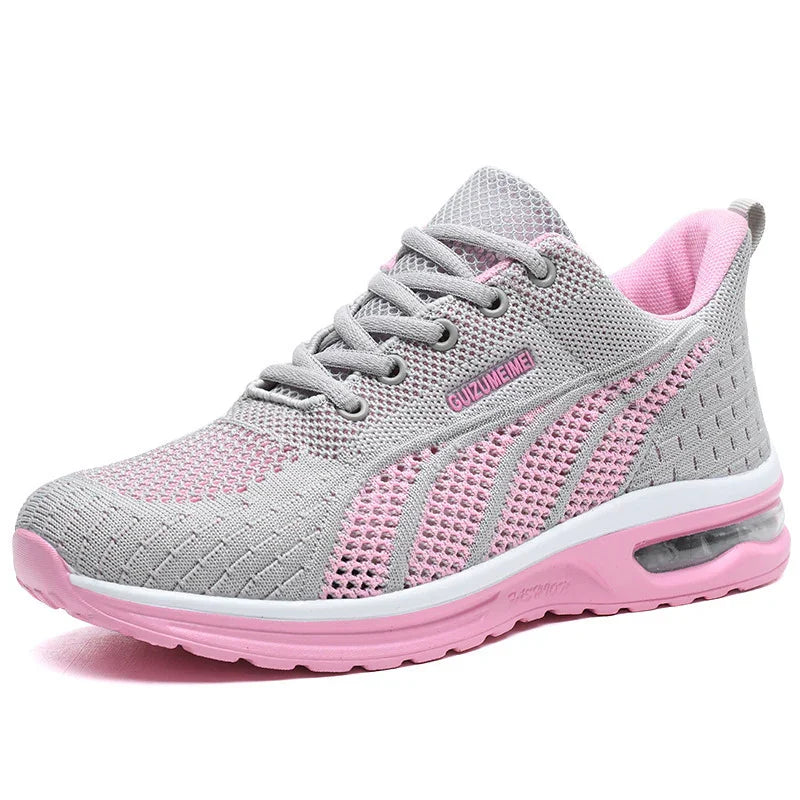 Women's grey and pink breathable mesh running shoe with cushioned sole and lace-up design