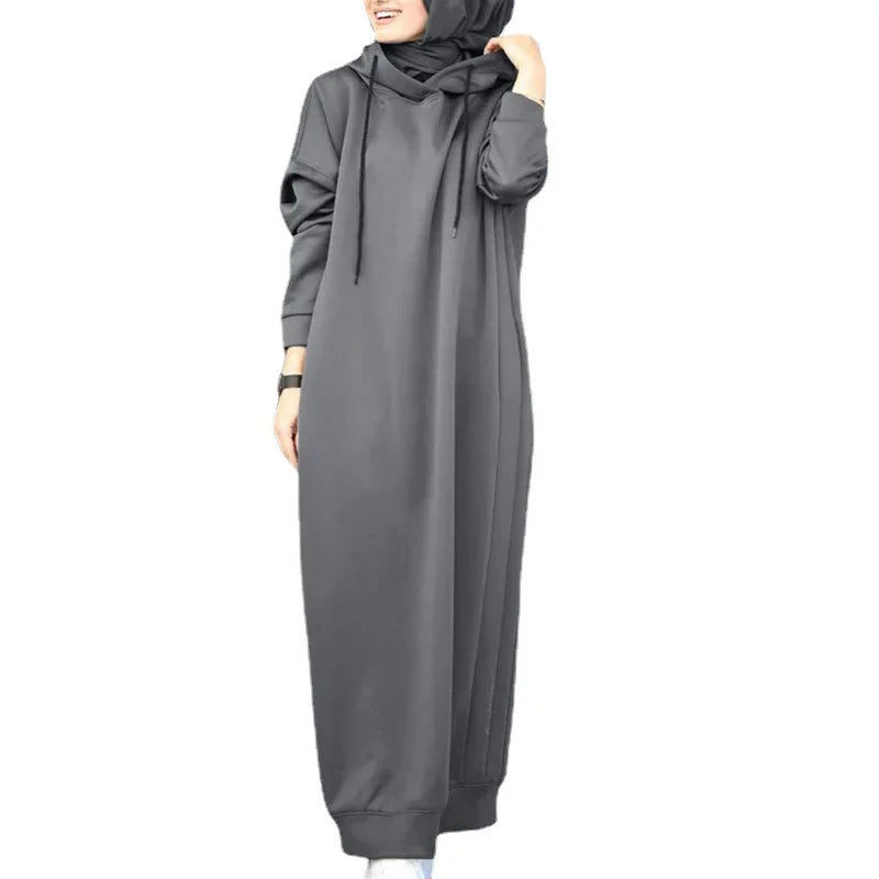 Woman wearing gray long hoodie dress with hood and drawstrings on white background