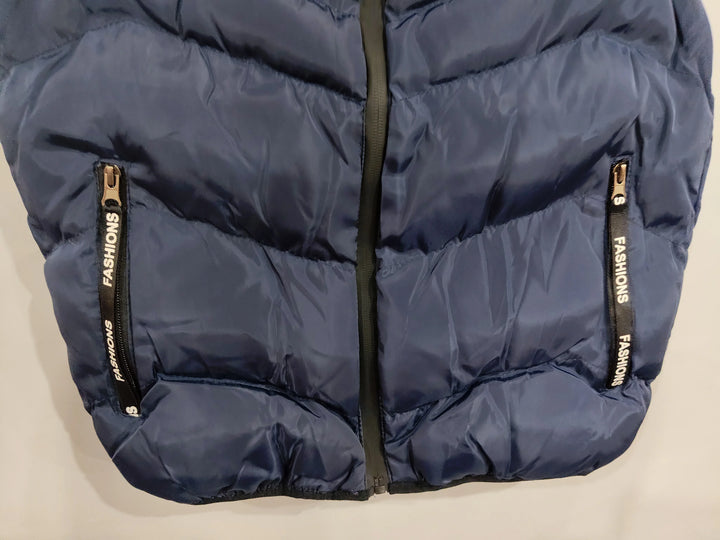 Close-up of navy blue puffer jacket with front zipper and zippered pockets labeled FASHIONS