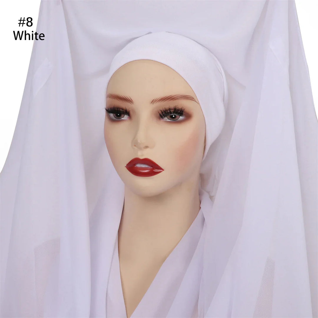 Mannequin head wearing white hijab underscarf with sheer white fabric draped around