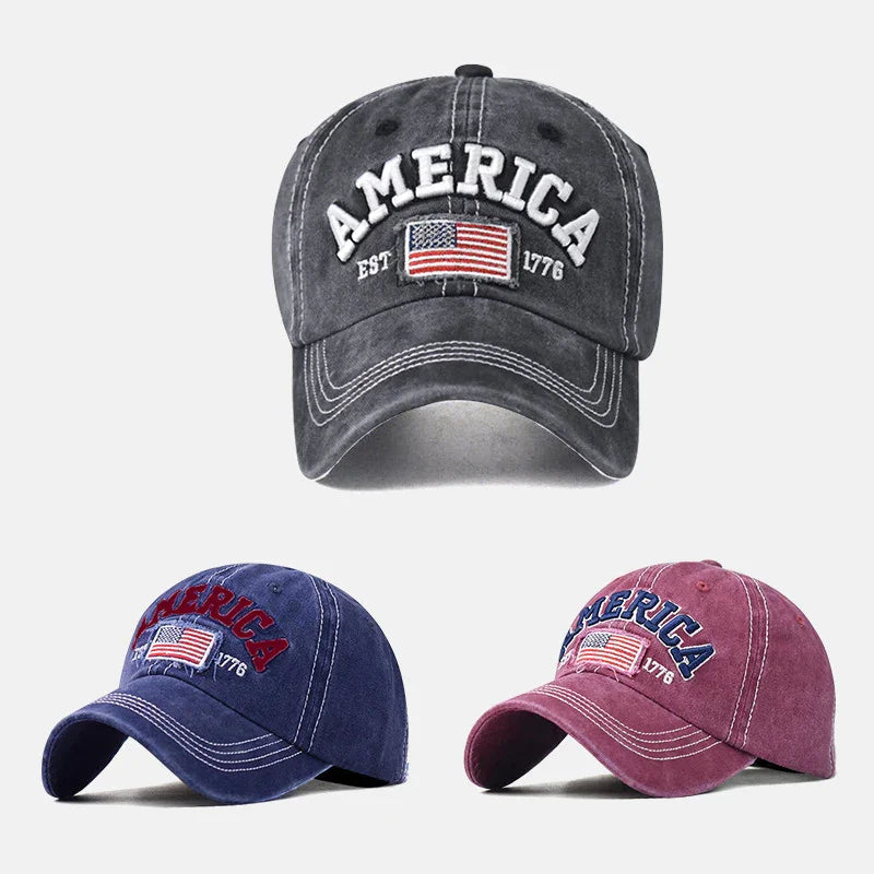 Three vintage-style America baseball caps with embroidered US flag and EST 1776 in black, blue, and red colors