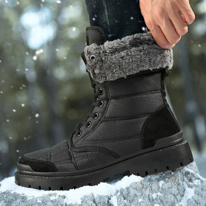 Black winter boots with gray fur lining worn in snowy outdoor setting