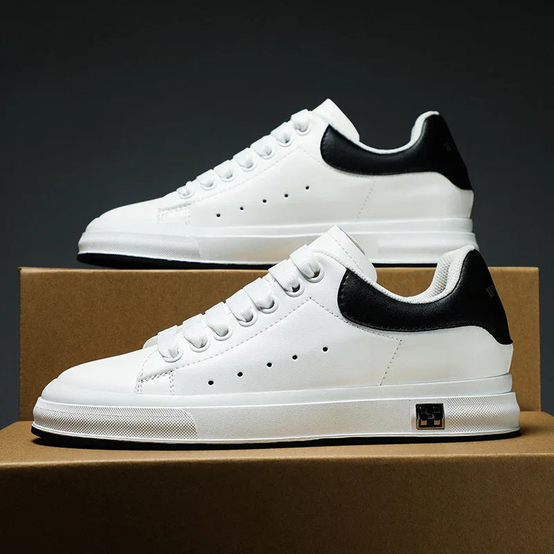 White leather sneakers with black heel accents on brown boxes against dark background