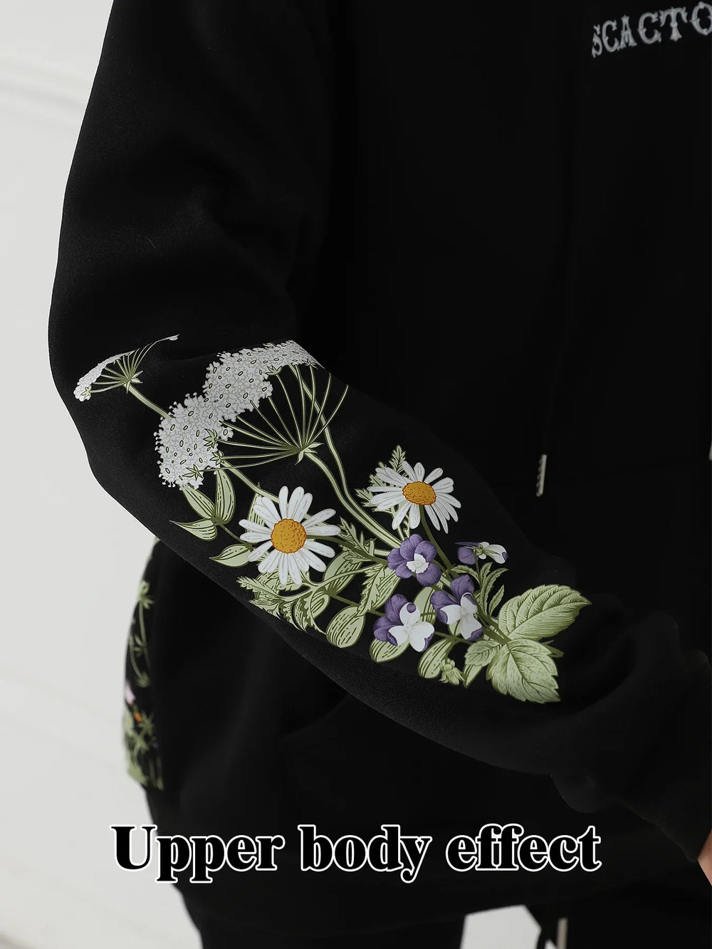Black hoodie sleeve with detailed white daisies and purple floral embroidery