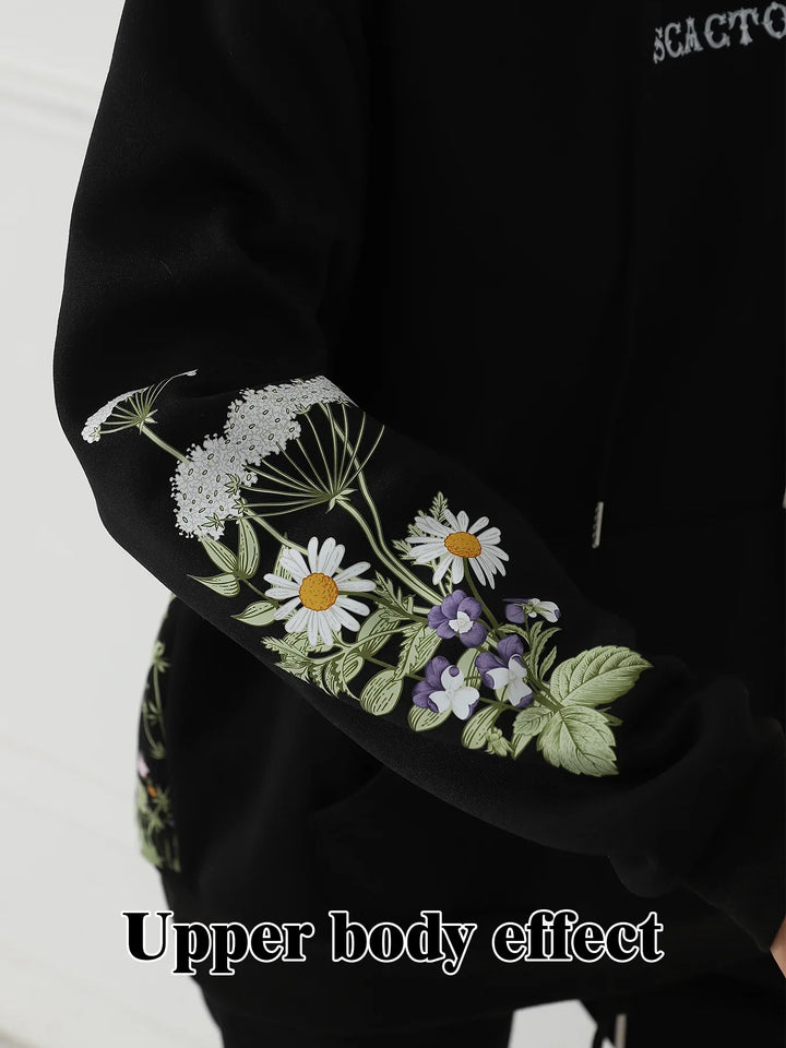 Black hoodie sleeve with detailed white daisies and purple floral embroidery