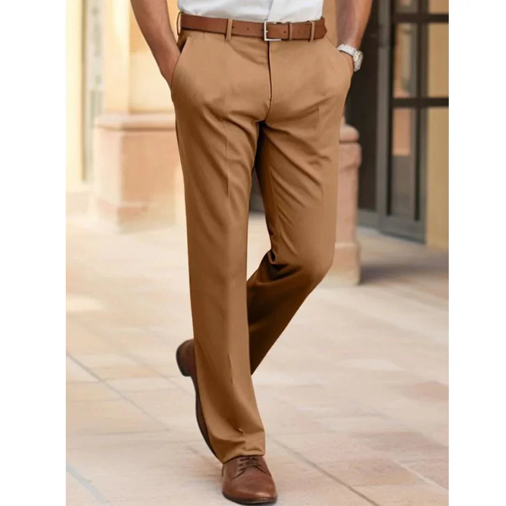 Man wearing tan dress pants with brown belt and leather shoes walking outdoors