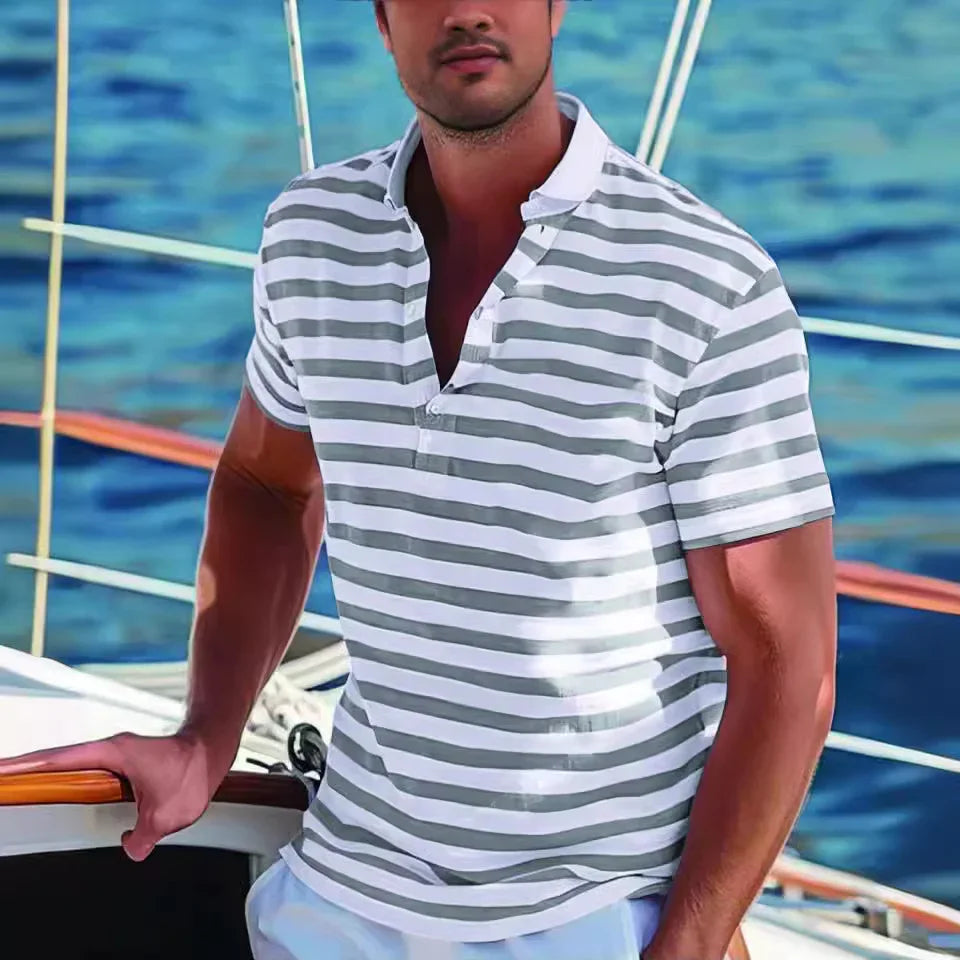 Man wearing gray and white striped polo shirt on a sailboat with blue water background