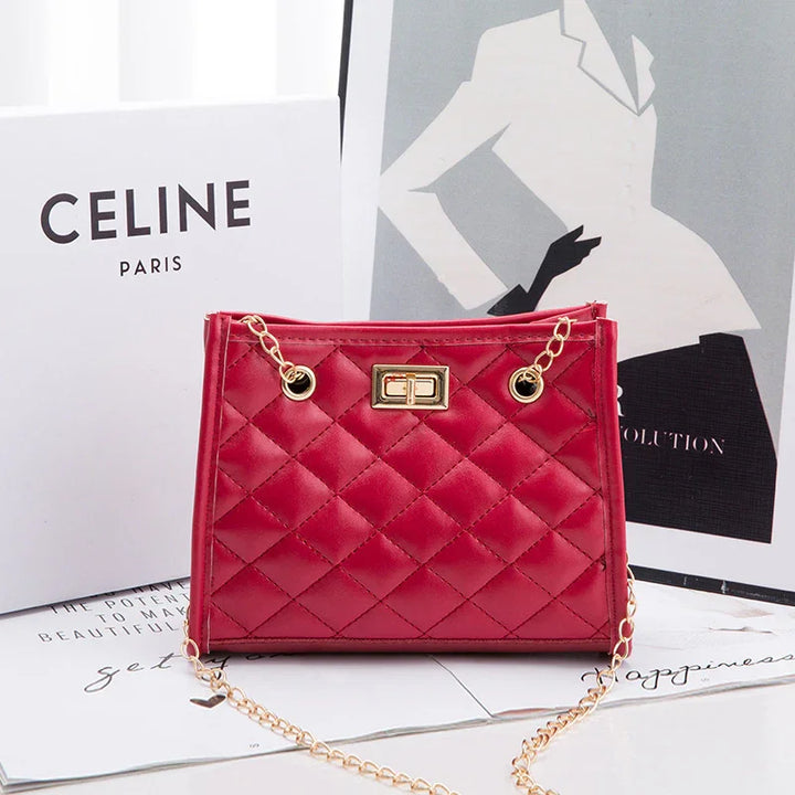 Red quilted leather handbag with gold chain and clasp, displayed with Celine Paris packaging