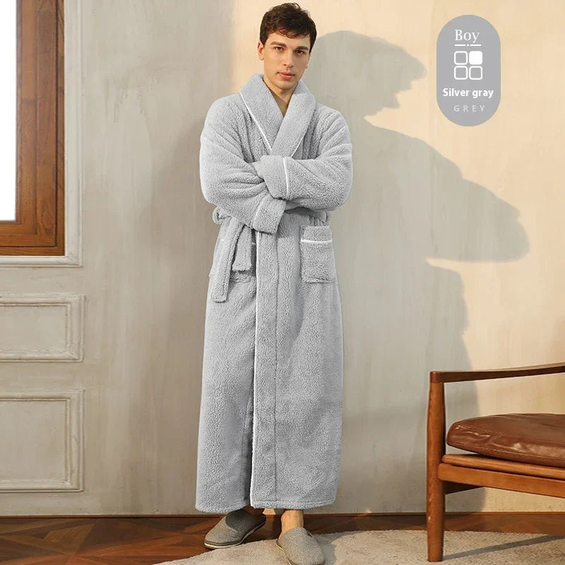 Man wearing silver gray plush bathrobe with pockets and belt indoors next to wooden chair
