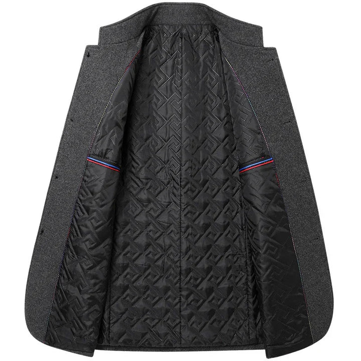 Open grey wool coat showing black quilted patterned interior lining with red and blue striped pocket edges