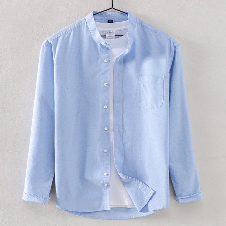Light blue casual button-up shirt with mandarin collar over white t-shirt on hanger