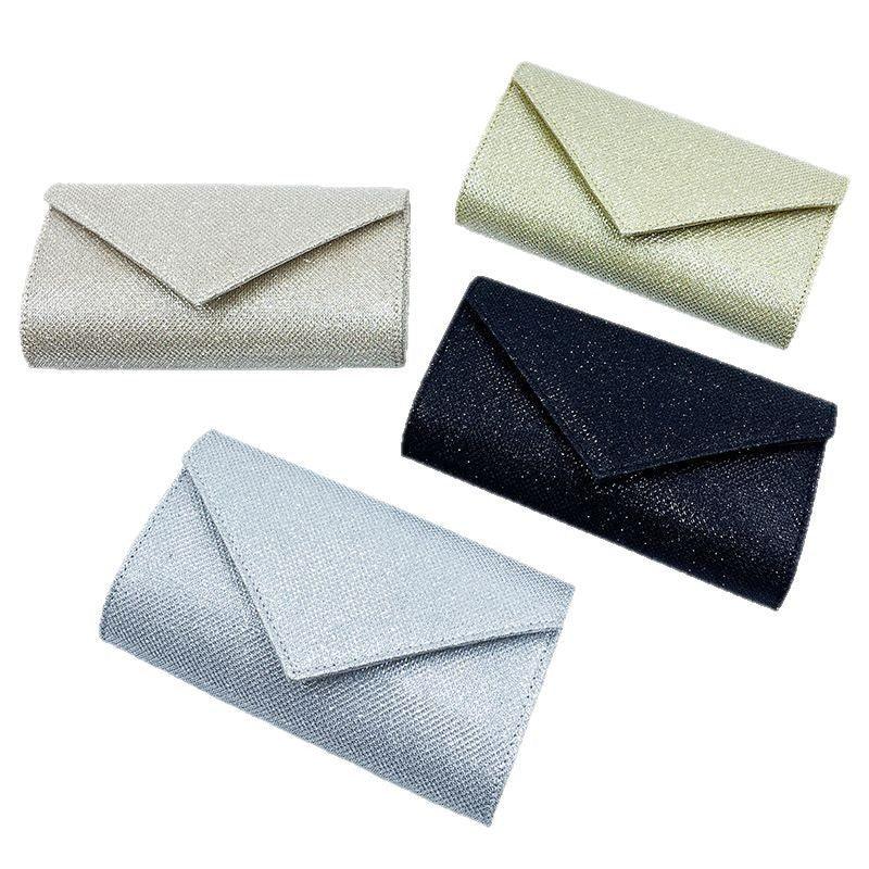 Set of four elegant glittery clutch purses in silver, gold, black, and light blue colors