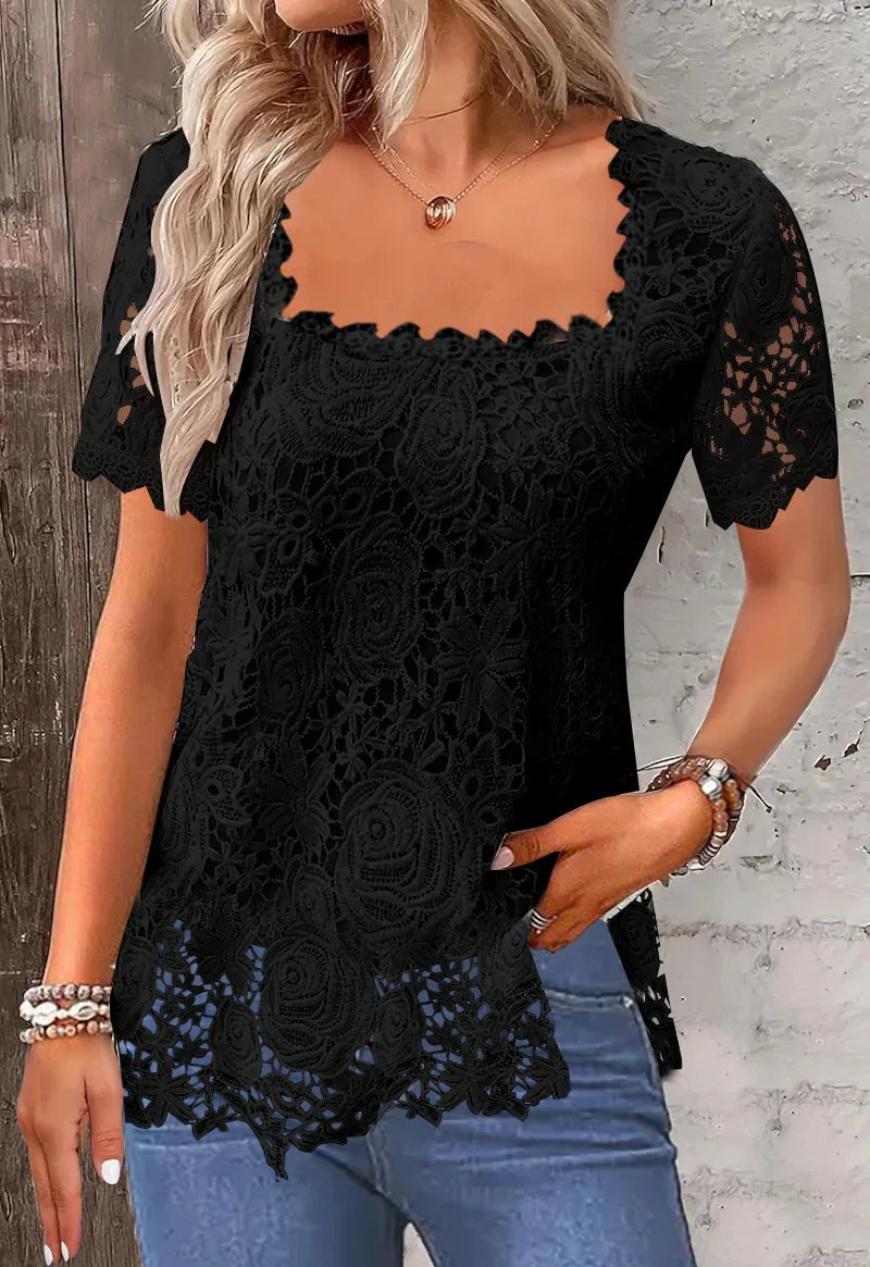 Woman wearing black lace floral short-sleeve blouse with scalloped square neckline and hem, blue jeans