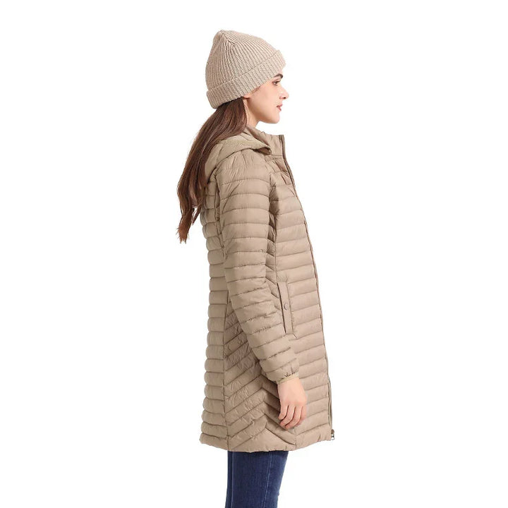 Woman wearing beige quilted puffer coat with hood and knit beanie, side view on white background