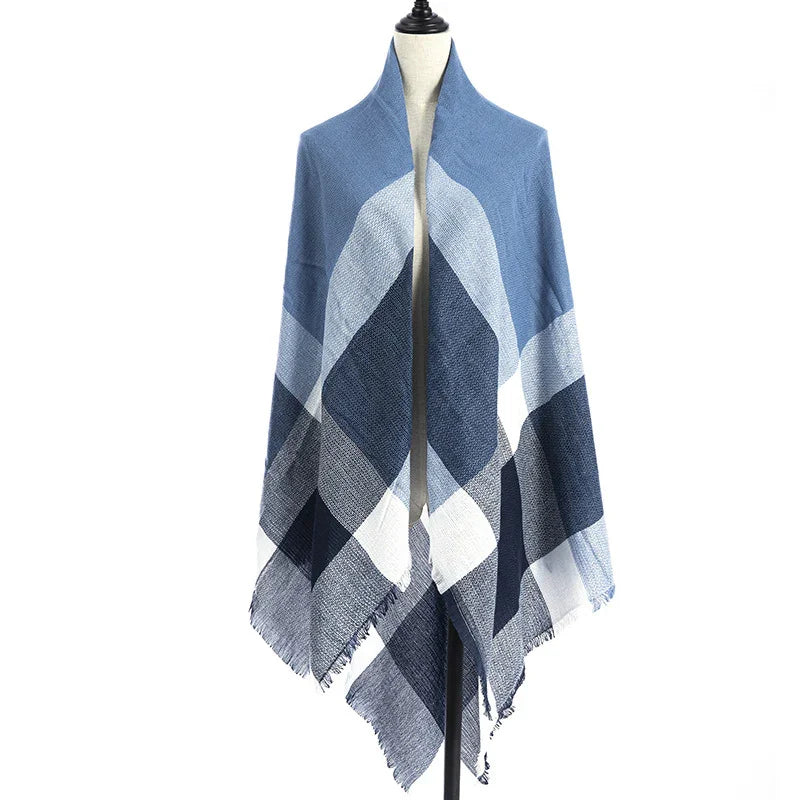 Blue and white plaid shawl with fringed edges displayed on a mannequin