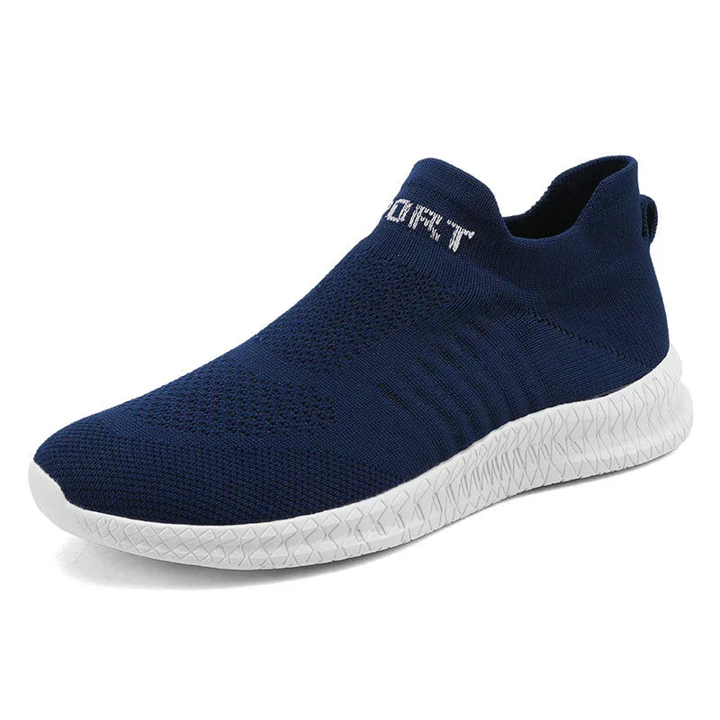Navy blue slip-on knit sneaker with white textured sole and elastic ankle collar