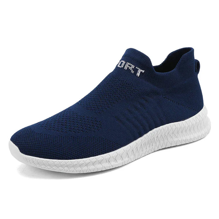 Navy blue slip-on knit sneaker with white textured sole and elastic ankle collar