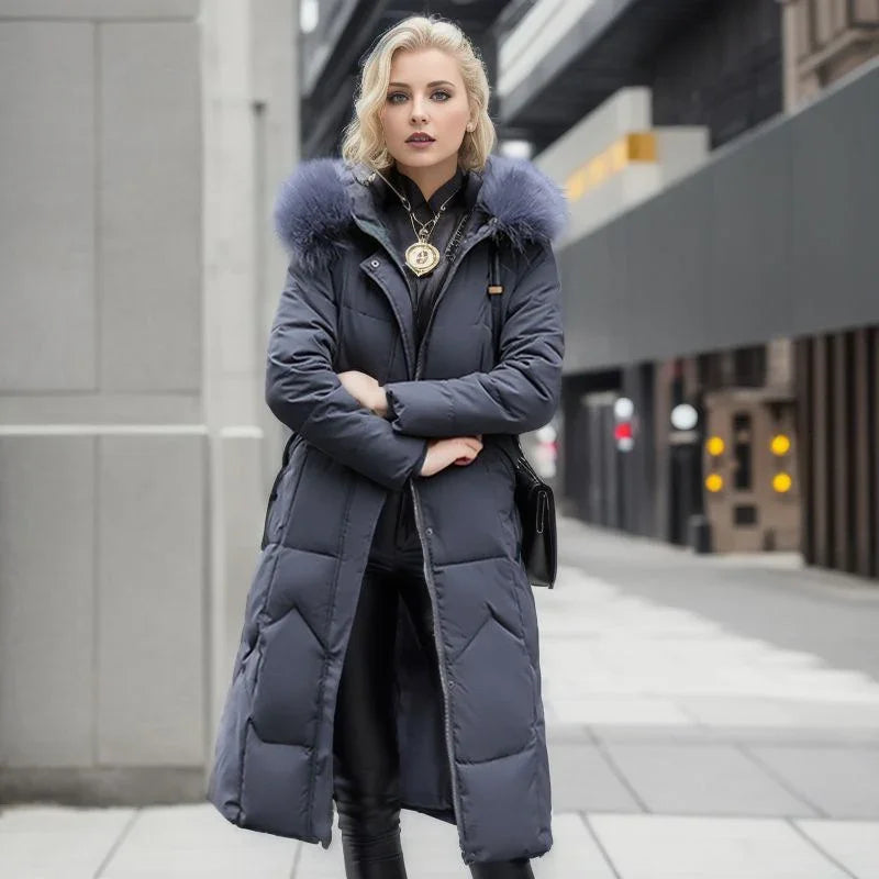 Blonde woman wearing long navy blue puffer coat with fur collar and black leather pants on city street