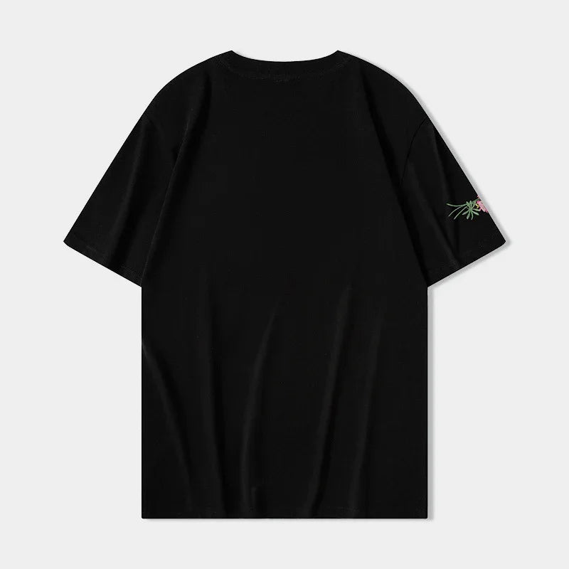 Black short-sleeve T-shirt with small floral embroidery on the right sleeve against white background