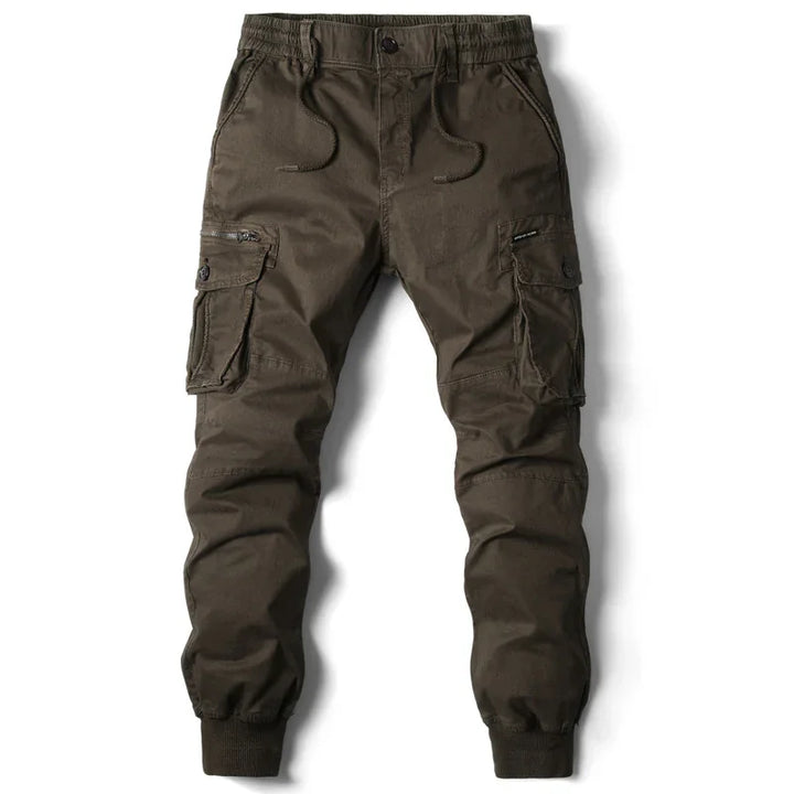 Men's brown cargo jogger pants with multiple pockets, drawstring waist, and cuffed ankles