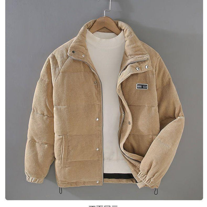 Beige corduroy puffer jacket with snap buttons and zipper on hanger over white crew neck sweater