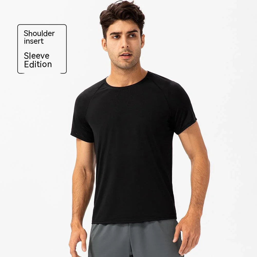 Man wearing black shoulder insert sleeve edition t-shirt, athletic activewear style.