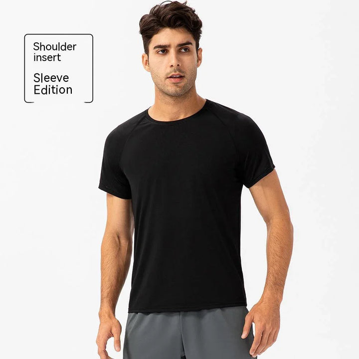 Man wearing black shoulder insert sleeve edition t-shirt, athletic activewear style.