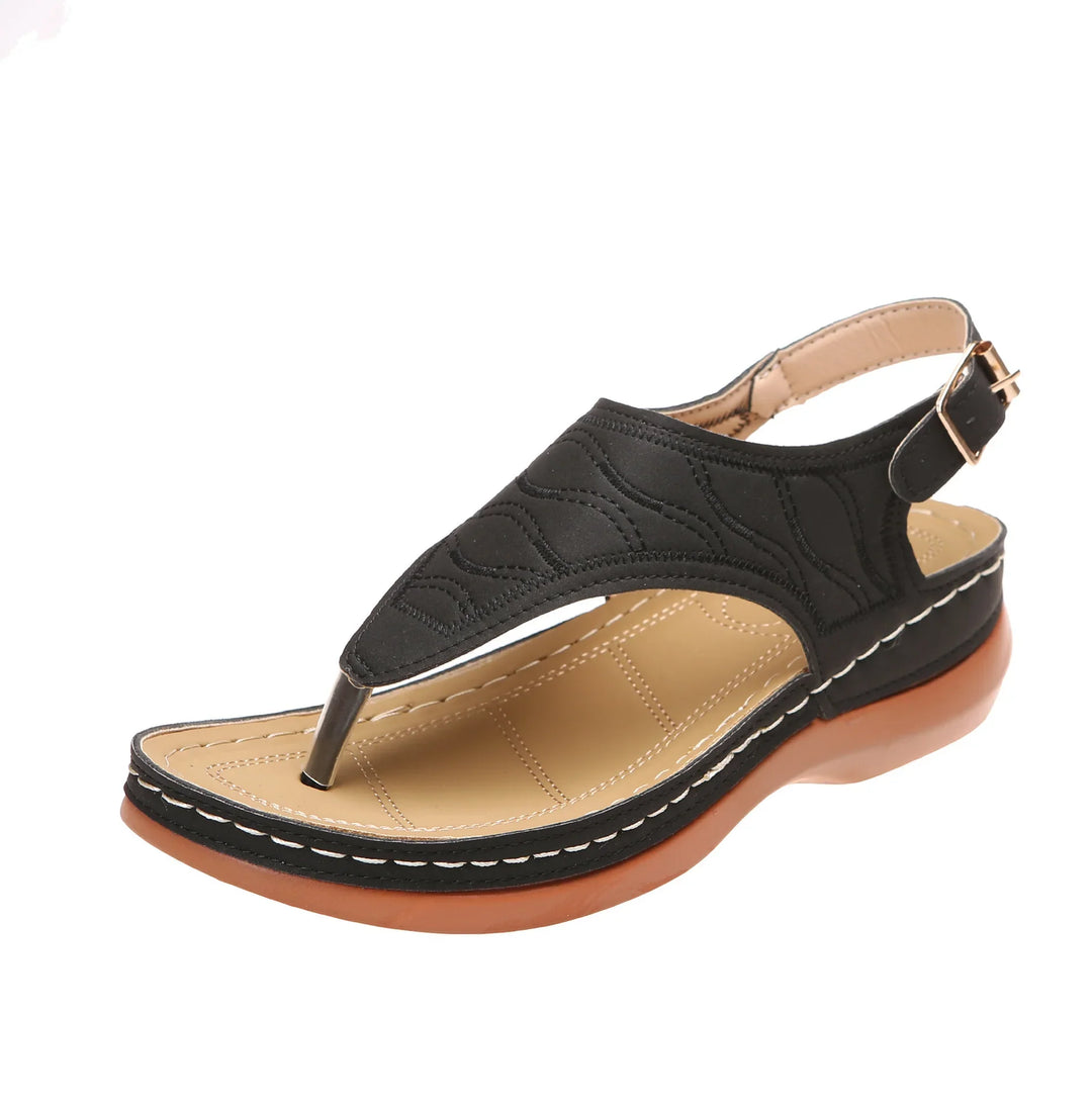 Black leather women's sandal with cushioned tan insole and brown rubber sole, slingback strap
