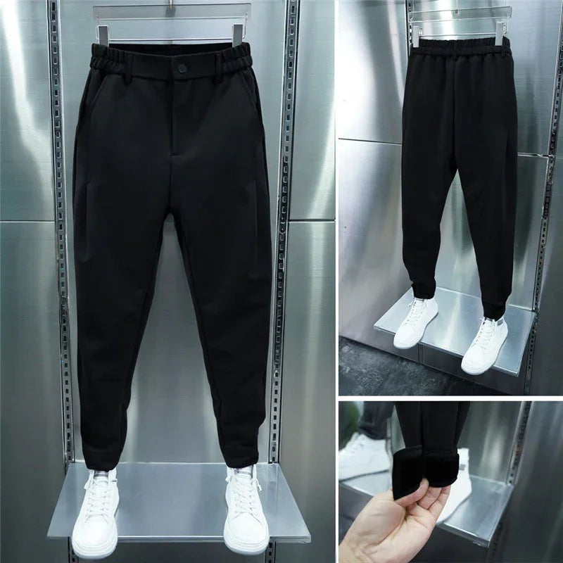 Black slim-fit casual pants with elastic waistband and cuffs, paired with white sneakers