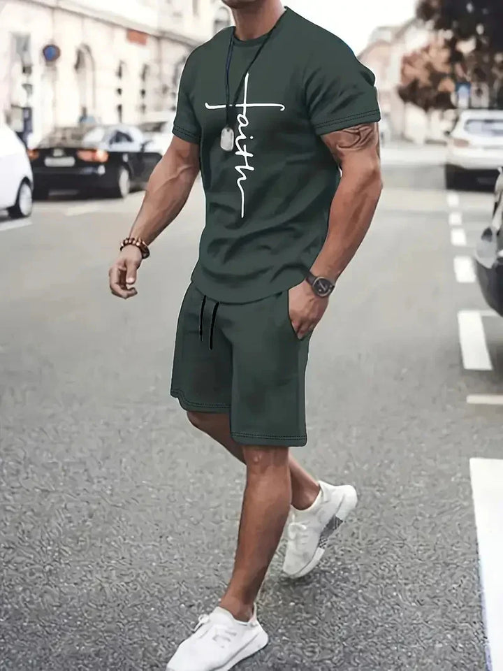 Man wearing dark green casual shorts and t-shirt with white faith cross design walking on city street