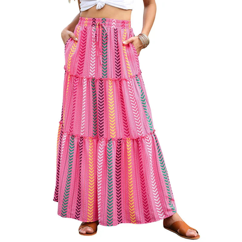 Woman wearing a colorful pink striped maxi skirt with pockets and sandals