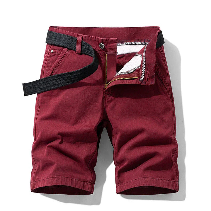Men's casual burgundy shorts with front zipper and black woven belt on white background