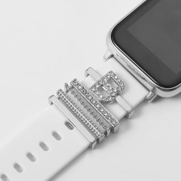 Smartwatch with white silicone band adorned with silver rhinestone rings including letter B charm