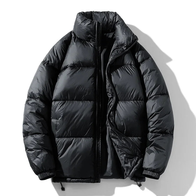 Black puffer jacket with high collar and zipper partially open on white background