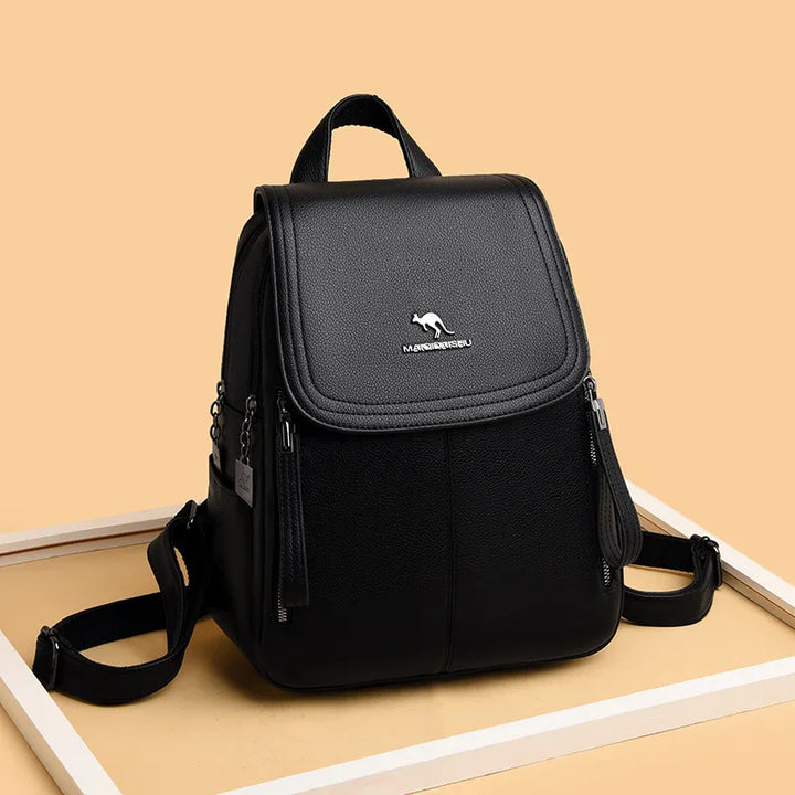 Black leather backpack with kangaroo logo and front zip pockets on beige background