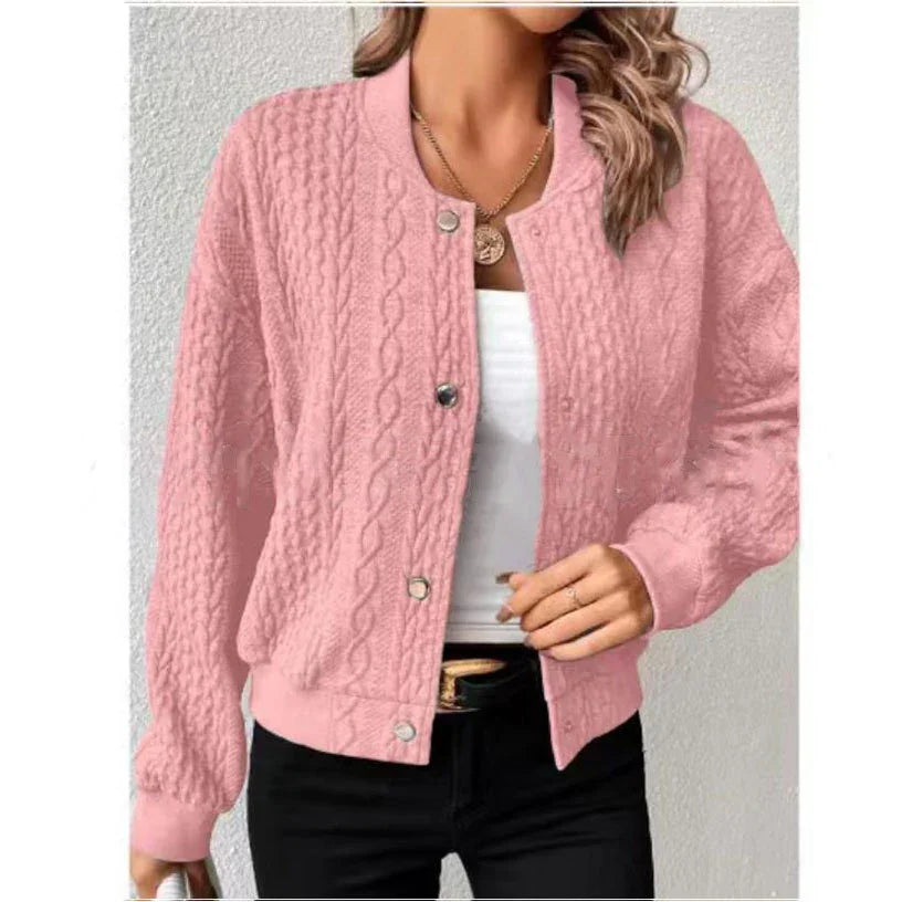 Woman wearing a pink cable knit button-up cardigan over a white top with black pants