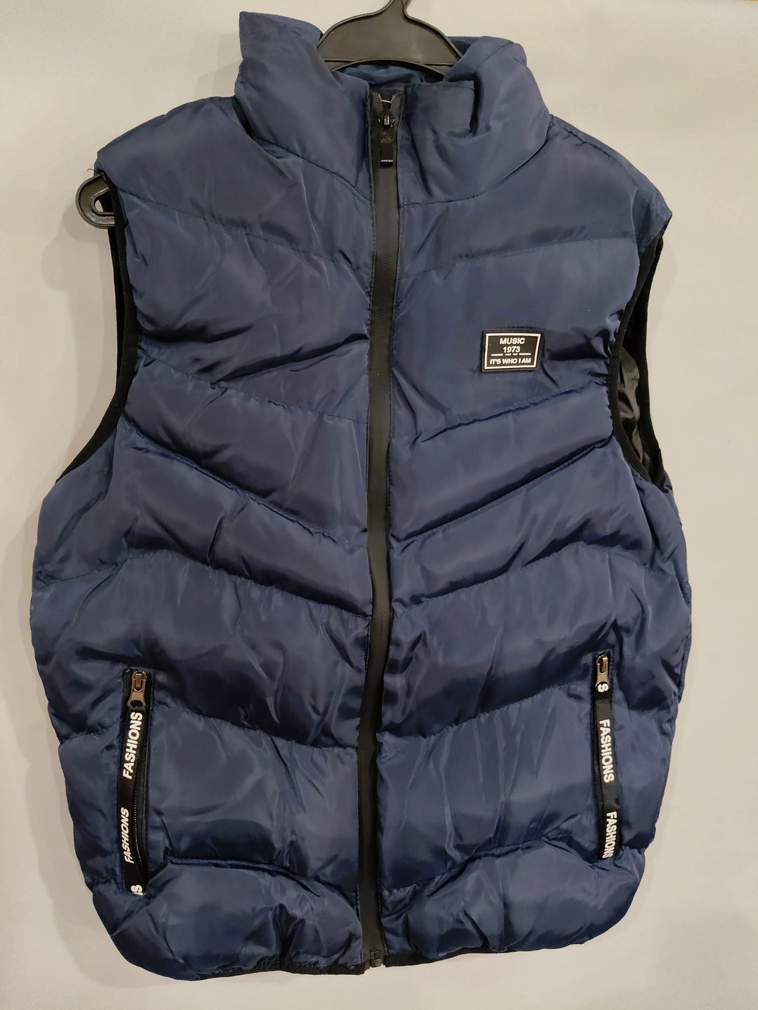 Navy blue padded vest with black zipper and pockets labeled 'Fashions', hanging on black hanger