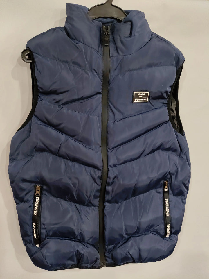 Navy blue padded vest with black zipper and pockets labeled 'Fashions', hanging on black hanger