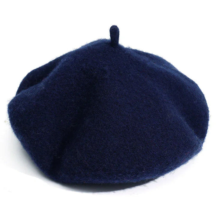 Navy blue wool beret hat with soft texture and top stem on white background